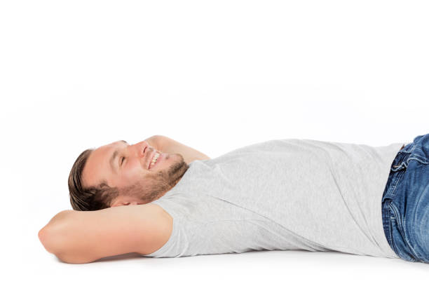 istock Carefree man smiling, laying on the floor. 916449608