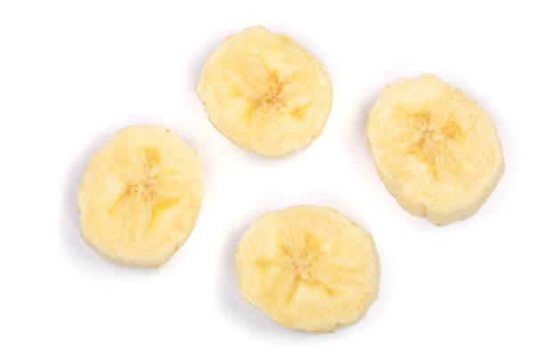 istock Banana slices isolated on a white background. Flat lay, top view 916450434