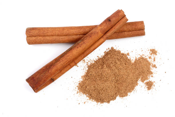 istock Cinnamon sticks with powder isolated on white background. Top view 916450742