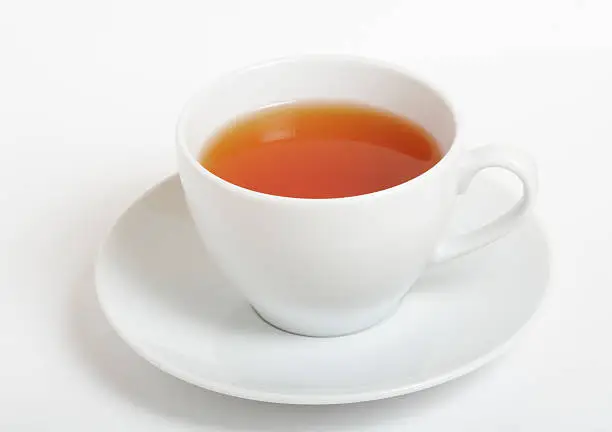 Cup of black tea on white background