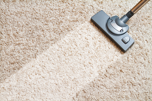 Close up of a professional carpet scrubber on a rug.