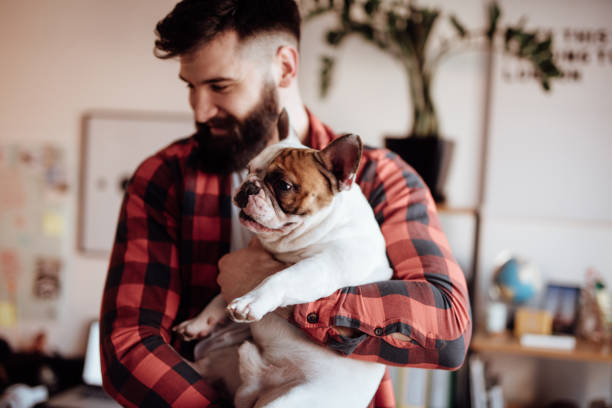 istock Bearded man holding his dog 916455828