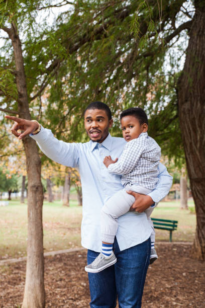 istock Dad carrying his young boy in his arms. 916460860