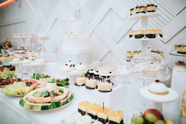 istock Delicious white wedding reception candy bar dessert table 916468090