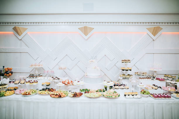 istock Delicious white wedding reception candy bar dessert table 916468478
