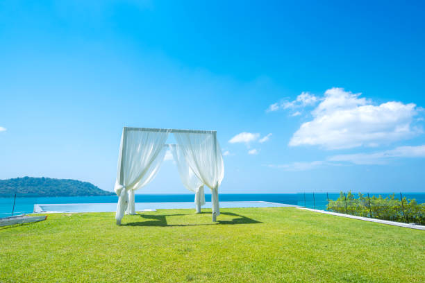 istock Outdoor Wedding Place on Green Grass Sea view 916468940
