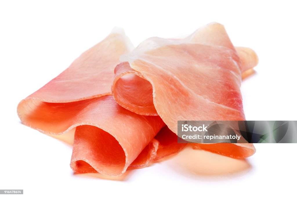 Italian prosciutto crudo or spanish jamon. Raw ham on white background. Italian prosciutto crudo or spanish jamon. Raw ham. Isolated on white background. Prosciutto Stock Photo