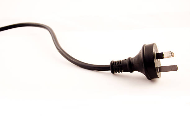 Black three prong power cord pm white background Black power cord against white background.http://i291.photobucket.com/albums/ll285/yellowtap/webisolatedobjects.jpg three pin plug stock pictures, royalty-free photos & images