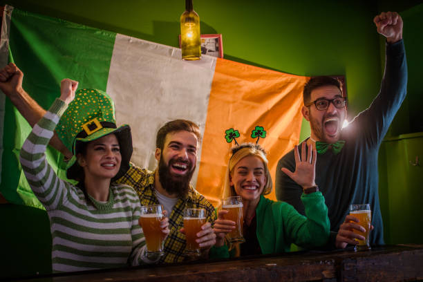istock Group of Friends Celebrating St Patrick's Day at Beer Pub 916481402