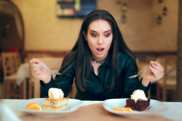 istock Girl Trying to Decide Between Vanilla and Chocolate Cake Dessert 916482490