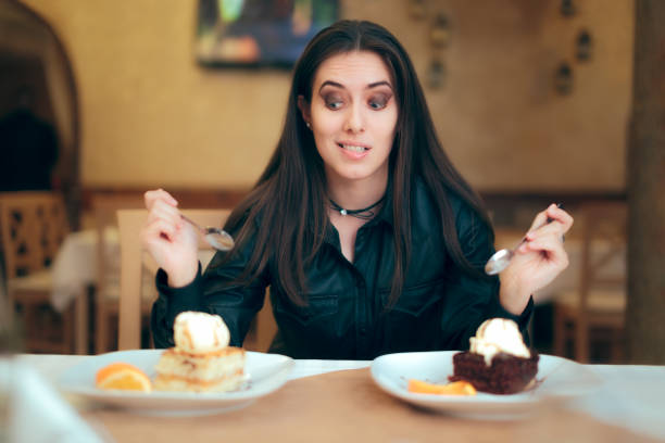 istock Girl Trying to Decide Between Vanilla and Chocolate Cake Dessert 916482492