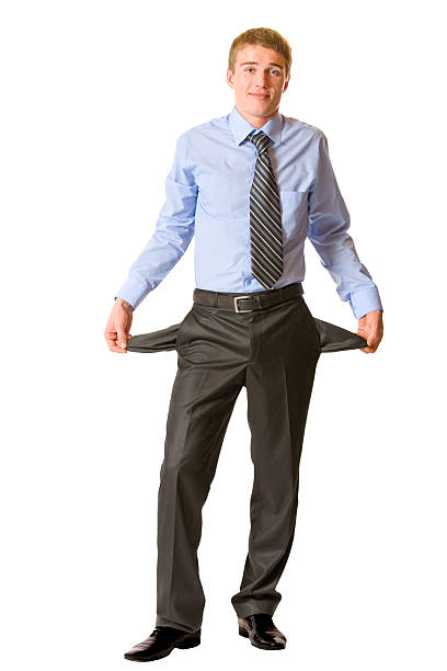 Isolated funny young businessman showing empty pockets, no cash stock photo