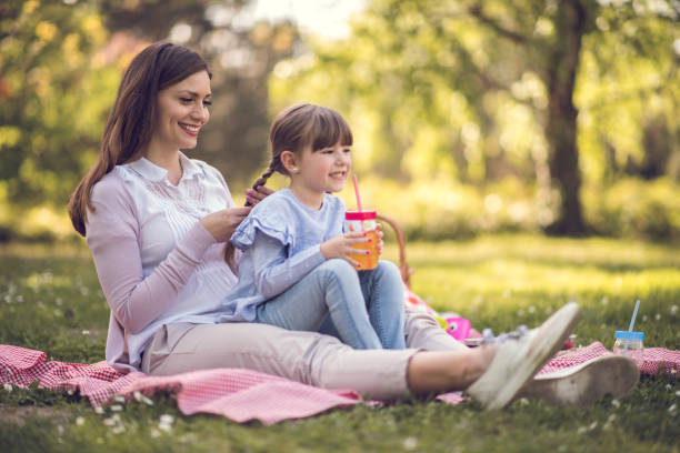 istock Mother and daughter enjoying picnic 916486110