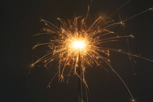 istock Close up of sparkler on grey background 916492120