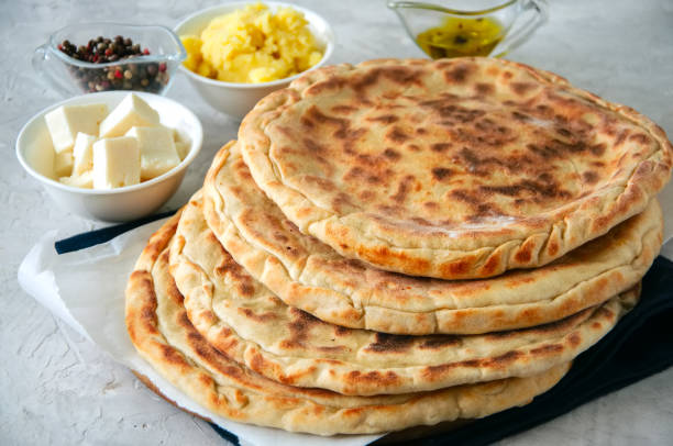 istock Mashed potato and sheep cheese filling flatbread on a white stone background. 916492264