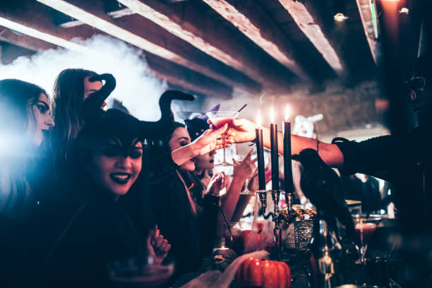 Barman giving cocktail to woman at Halloween party Barman working at Halloween nightclub party giving cocktail to woman in scary costume vampire photos stock pictures, royalty-free photos & images