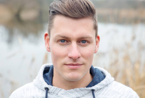 istock handsome blond man in front of lake 916496898