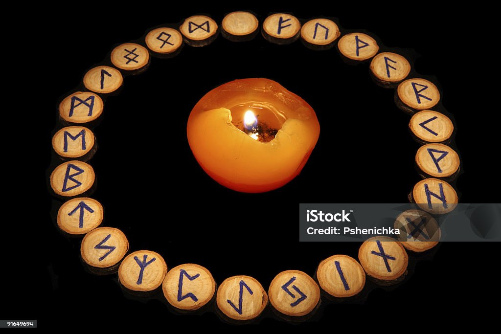 Runes with candle  Alphabet Stock Photo