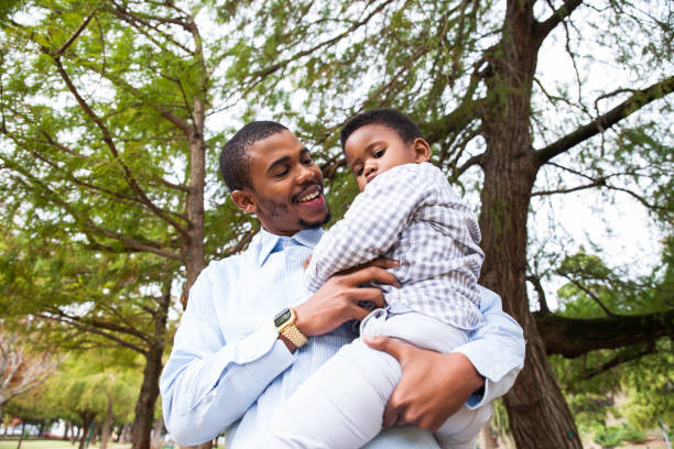 istock Dad holding his beautiful son in his arms. 916498938