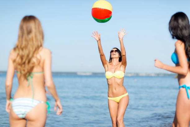istock girls with ball on the beach 916511436
