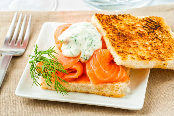 Gravad lax Gravad lax salmon on toast with dill sauce. gravad stock pictures, royalty-free photos & images