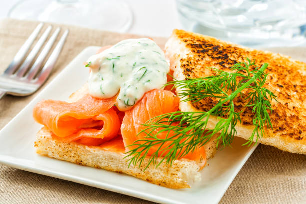 Swedish gravlax Swedish gravlax or gravad lax salmon served on toast with a dill sauce. gravad stock pictures, royalty-free photos & images