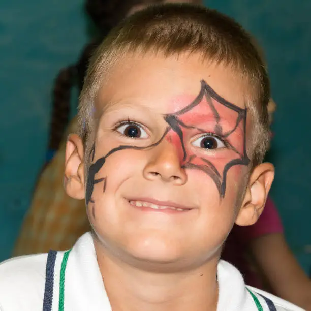 The masked boy looks into the camera