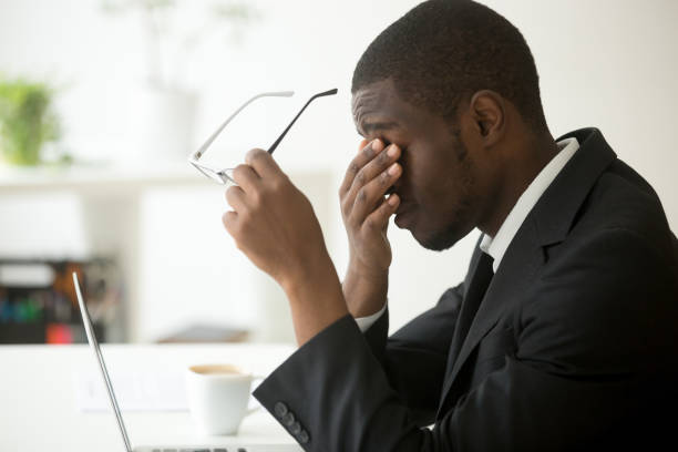 istock Tired of computer african businessman taking off glasses feeling eyestrain 916519980