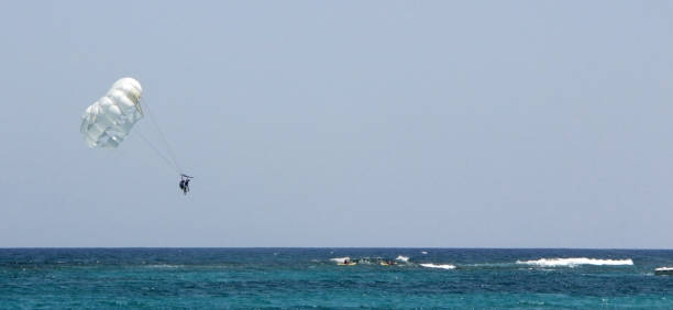istock Parachute flight over the sea. 916520032