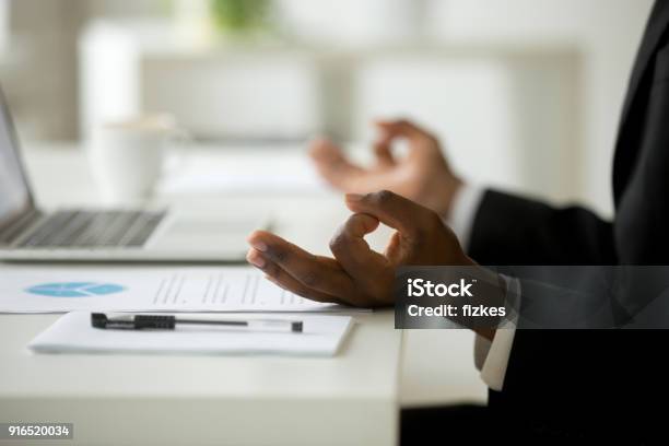 Africanamerican Businessman In Suit Meditating In Office Close Up View Stock Photo - Download Image Now