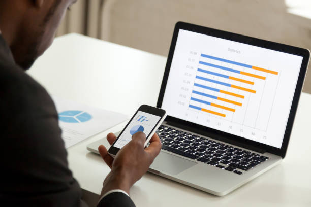 istock African american businessman using devices for business, over shoulder view 916520044