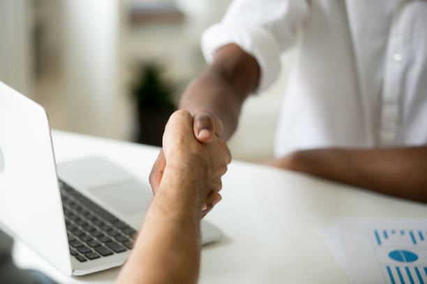 istock Multiracial business handshake concept, african and caucasian partners shaking hands 916520078
