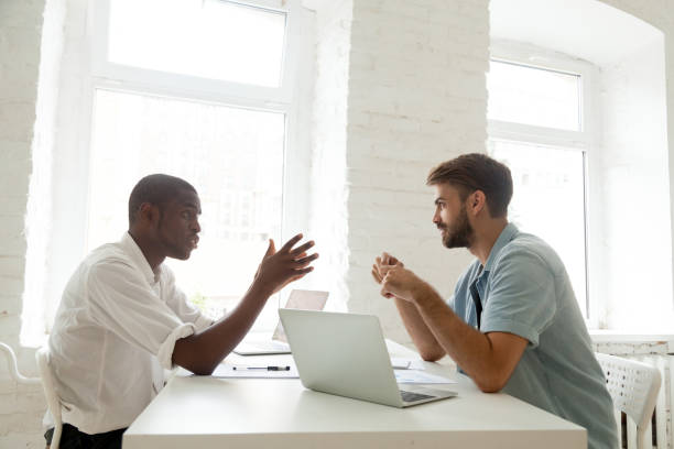 African-american and caucasian colleagues brainstorming new startup idea at work