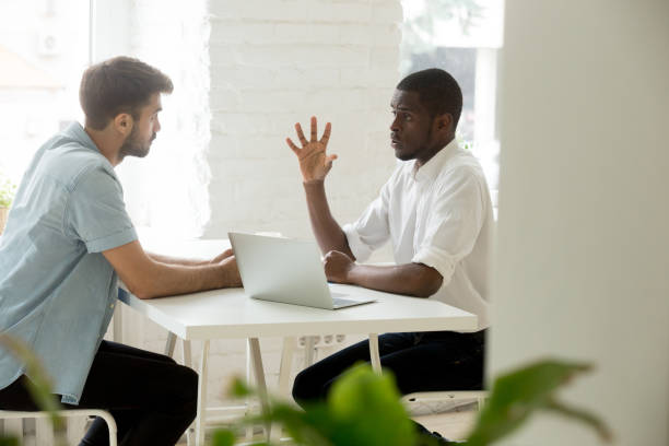istock Focused african manager explaining making business offer to caucasian client 916520172