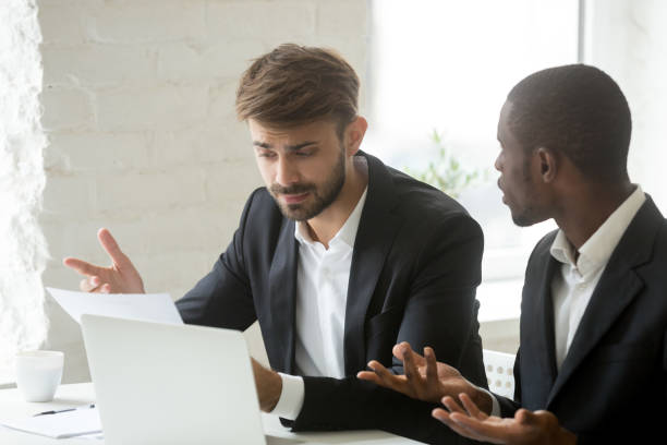 istock Multi-ethnic colleagues having fight arguing about mistake in business document 916520174