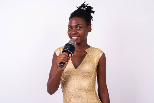 istock Young African Woman Singer Performing And Using Microphone Against White Background 916529434