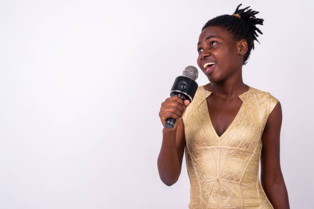 istock Young African Woman Singer Performing And Using Microphone Against White Background 916529894