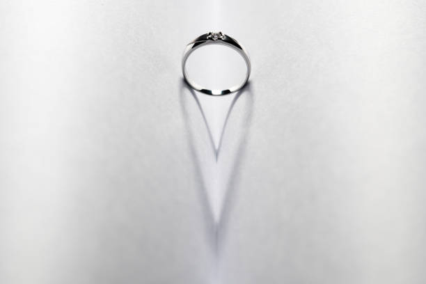 istock Platinum wedding and shadow look like a heart 916530038