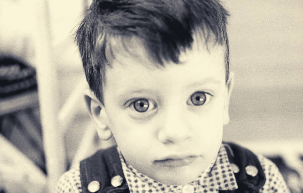 vintage portrait of a toddler looking close at camera - 20th century style flash imagens e fotografias de stock
