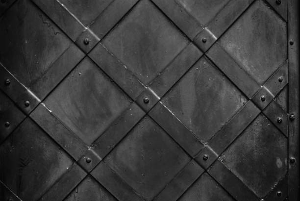 istock Metal decor on the old black door, crossed strips 916536780