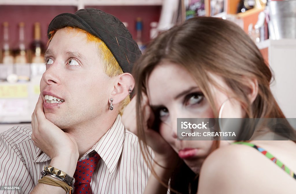 Distracted young man and bored woman  Couple - Relationship Stock Photo