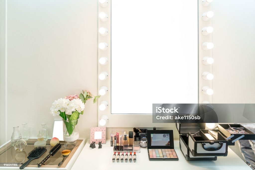 Modern closet room with make-up vanity table, mirror and cosmetics product in flat style house. Make-Up Stock Photo