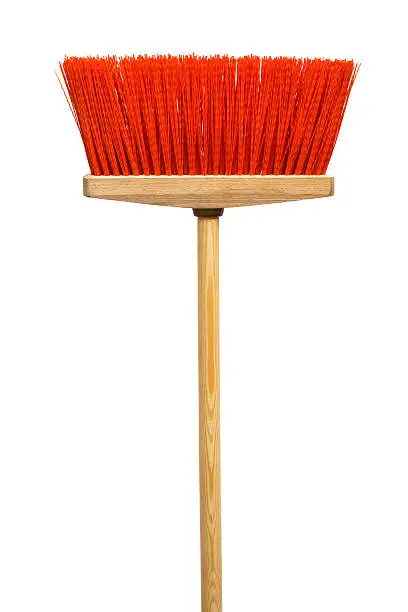 Photo of Wooden broom with red bristles on a white background