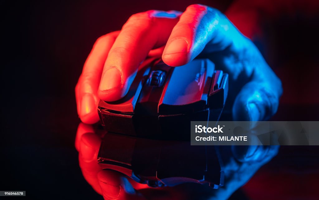Human Hand over th High technology computer gaming mouse Close up of Hand over wireless Game Mouse on dark background ; The finger ready to click Video Game Stock Photo