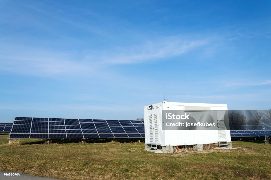 Distribution point at solar panels photovoltaics power station, energy innovation Distribution point at solar panels photovoltaics power station farm, future innovation energy concept, clear blue sky background, Czech Republic Storage Room Stock Photo