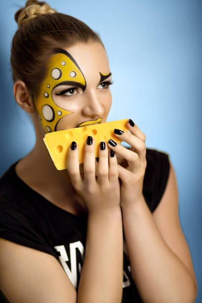 beautiful fashion photo Creative make-up new conceptual idea. yellow white bold art painting. Crazy graphic abstract picture woman face surrealistic. professional photo. Creativity pop art, lines shadows, long black nails person holding frame over face stock pictures, royalty-free photos & images