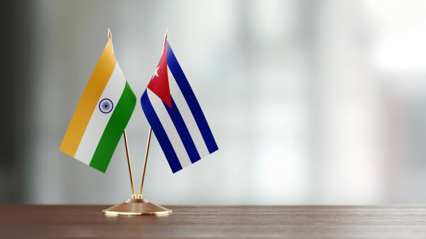 istock Cuban And Indian Flag Pair On A Desk Over Defocused Background 916557358