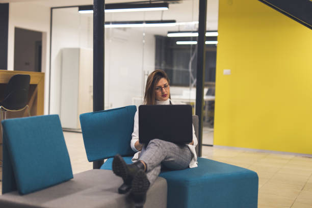 istock Woman in the modern office surfing the net 916557830