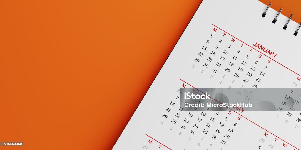 White Calendar On Orange Background White calendar on orange background. January and may months are visible. Panoramic composition with copy space. Calendar and reminder concept with selective focus. Calendar Stock Photo