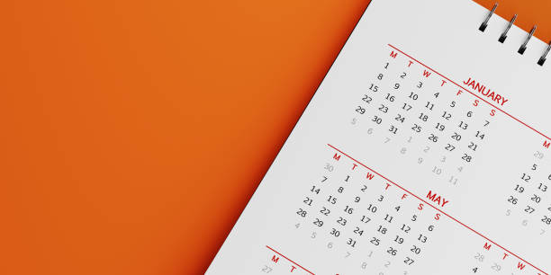 White Calendar On Orange Background White calendar on orange background. January and may months are visible. Panoramic composition with copy space. Calendar and reminder concept with selective focus. annual event photos stock pictures, royalty-free photos & images
